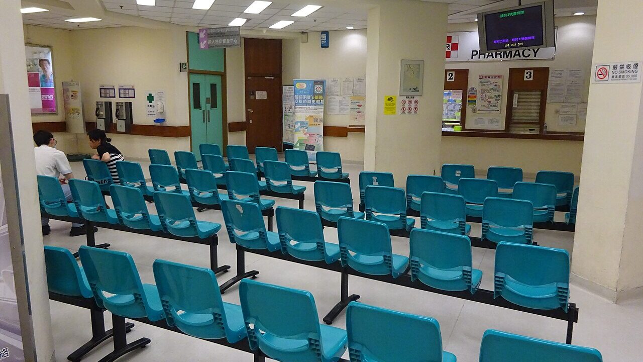 Sala de espera de hospital com fileiras de cadeiras vazias